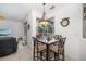 Bright dining area with modern lighting and a view of the screened-in patio at 9101 Yarberry St, Sarasota, FL 34240