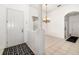 Open entryway with tile flooring, chandelier lighting, and a view into other rooms at 9101 Yarberry St, Sarasota, FL 34240