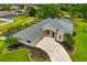 Beautifully landscaped home exterior with a paved driveway and attached garage at 9101 Yarberry St, Sarasota, FL 34240