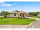 Well-maintained single Gathering home has a manicured lawn, mature palms, and a red front door at 9101 Yarberry St, Sarasota, FL 34240