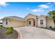 Charming single Gathering home featuring manicured lawn, circular driveway, and attached two car garage at 9101 Yarberry St, Sarasota, FL 34240