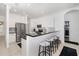 Modern kitchen with stainless steel appliances, bar seating, and white cabinetry for a sleek design at 9101 Yarberry St, Sarasota, FL 34240