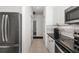 Modern kitchen with stainless steel appliances and white cabinetry with black hardware at 9101 Yarberry St, Sarasota, FL 34240