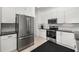 Modern kitchen featuring stainless steel appliances, white cabinetry, and tile backsplash at 9101 Yarberry St, Sarasota, FL 34240