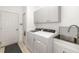 Functional laundry room featuring white cabinets, sink, and modern appliances at 9101 Yarberry St, Sarasota, FL 34240