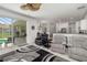 Open concept living room with view of patio and kitchen with stainless steel appliances at 9101 Yarberry St, Sarasota, FL 34240