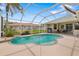 Screened in pool and lanai with palm trees and outdoor seating with a view of the backyard at 9101 Yarberry St, Sarasota, FL 34240