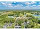 Expansive aerial view highlighting community amenities: golf course, tennis courts, pool, and residential buildings at 9734 Carnoustie Pl, Bradenton, FL 34211