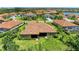 This aerial shot showcases a single-Gathering home with landscaping, tile roof, and community at 9734 Carnoustie Pl, Bradenton, FL 34211