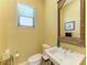 Bright half bathroom featuring a stylish sink, and toilet at 9734 Carnoustie Pl, Bradenton, FL 34211