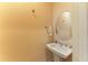 Half bath featuring a pedestal sink, mirror, and wall mounted towel rack at 9734 Carnoustie Pl, Bradenton, FL 34211
