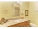 Bathroom featuring granite countertops, tiled shower, framed mirror and decorative accents at 9734 Carnoustie Pl, Bradenton, FL 34211