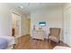 Bedroom with hardwood floors, a chair, dresser, and a TV at 9734 Carnoustie Pl, Bradenton, FL 34211