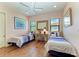 bedroom with two twin beds, hardwood floors, and natural lighting at 9734 Carnoustie Pl, Bradenton, FL 34211