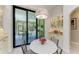 Bright dining area with glass sliders to an outdoor patio, a chandelier, and custom built in cabinetry at 9734 Carnoustie Pl, Bradenton, FL 34211