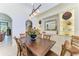 Elegant dining room with built-in shelving and a wooden table perfect for Gathering gatherings at 9734 Carnoustie Pl, Bradenton, FL 34211