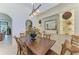 Elegant dining room with built-in shelving and a wooden table perfect for Gathering gatherings at 9734 Carnoustie Pl, Bradenton, FL 34211