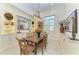 Cozy dining room featuring built-in cabinets, elegant lighting, and a wooden table with seating at 9734 Carnoustie Pl, Bradenton, FL 34211