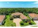 Beautiful home featuring a brick driveway, tiled roof, and well-maintained landscaping at 9734 Carnoustie Pl, Bradenton, FL 34211