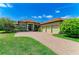 Single Gathering home with a three-car garage, paver driveway, and mature landscaping at 9734 Carnoustie Pl, Bradenton, FL 34211