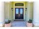 A charming front entrance with decorative planters framing the entryway at 9734 Carnoustie Pl, Bradenton, FL 34211