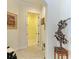 Hallway with decorative art and a doorway leading to another room in the home at 9734 Carnoustie Pl, Bradenton, FL 34211