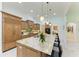 Spacious kitchen with a large island, granite countertops, and stainless steel appliances at 9734 Carnoustie Pl, Bradenton, FL 34211