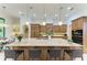Spacious kitchen with a large island, pendant lighting, and a breakfast bar with seating at 9734 Carnoustie Pl, Bradenton, FL 34211
