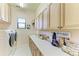 Functional laundry room featuring a washer, dryer, and plenty of storage space at 9734 Carnoustie Pl, Bradenton, FL 34211