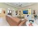 Well-lit living room with a large entertainment center and comfortable seating at 9734 Carnoustie Pl, Bradenton, FL 34211