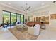 Bright living room featuring neutral tones, modern furniture, and seamless access to outdoor patio at 9734 Carnoustie Pl, Bradenton, FL 34211