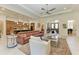 Open-concept living room with a view into the kitchen and a large leather couch at 9734 Carnoustie Pl, Bradenton, FL 34211