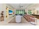Spacious living room with built-in shelving, stylish furniture, and access to the outdoors at 9734 Carnoustie Pl, Bradenton, FL 34211