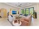 Bright living room featuring a built-in entertainment center and large glass doors to the lanai at 9734 Carnoustie Pl, Bradenton, FL 34211