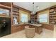 Spacious office with custom built-in bookshelves and a large desk for maximum productivity at 9734 Carnoustie Pl, Bradenton, FL 34211