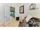 View through doorway into office with a piano and view of the living room through another doorway at 9734 Carnoustie Pl, Bradenton, FL 34211