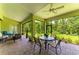 Enclosed patio featuring brick pavers and comfortable seating with a view of the lush green landscape at 9734 Carnoustie Pl, Bradenton, FL 34211