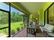 Spacious outdoor patio with brick flooring, offering a comfortable space with views of the serene backyard and landscaping at 9734 Carnoustie Pl, Bradenton, FL 34211