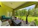 Inviting screened-in patio with ample seating and a peaceful view of the private, well-manicured backyard at 9734 Carnoustie Pl, Bradenton, FL 34211