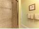 Walk-in shower with tile surround, glass door, and upscale fixture details at 9734 Carnoustie Pl, Bradenton, FL 34211