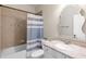 Bathroom featuring a shower-tub combination and a decorative mirror above the sink at 13116 Bliss Loop, Bradenton, FL 34211