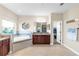 Spacious bathroom featuring a soaking tub, double vanity with granite countertop and dark wood cabinets at 13116 Bliss Loop, Bradenton, FL 34211