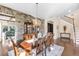 Dining room boasts wood floors, decorative chandelier and a stunning stone accent wall at 13116 Bliss Loop, Bradenton, FL 34211