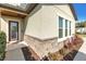 Home's entrance with stone accent, decorative wreath, and manicured landscaping at 13116 Bliss Loop, Bradenton, FL 34211