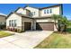 Home with two car garage, landscaped yard, stone accents and palm trees at 13116 Bliss Loop, Bradenton, FL 34211