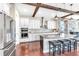 Kitchen with hardwood floors, stainless steel appliances, island with seating and stone accent wall at 13116 Bliss Loop, Bradenton, FL 34211