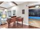 Living room with wood flooring, baby grand piano and pool view at 13116 Bliss Loop, Bradenton, FL 34211