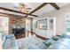 Comfortable living area with wooden beams, custom built-ins and stone accents at 13116 Bliss Loop, Bradenton, FL 34211