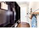 Mudroom featuring custom built-in storage with coat hooks, shelves, and a welcome mat at 13116 Bliss Loop, Bradenton, FL 34211