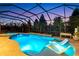 A screened-in pool with waterfall feature and in-pool lounge chairs at 13116 Bliss Loop, Bradenton, FL 34211